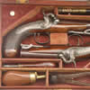 A very pretty pair of Irish pocket/travelling pistols by Trulock and Son of Dublin ca 1830. Back action percussion locks, captive ramrods, blued steel furniture, ovate form barrels with 'Trulock and Son Dublin' and Irish marks to them. In their red velvet lined mahogany case together with numerous accessories including flask, mould, nipple key and ramrod. The pistols themselves retain some 80%+ of their original finish with certain light fading to the barrel brown, traces of case hardening colour to the tang, breech plug and lock plate which are all crisp with some patination and original blue to the trigger guards, ramrod pipes and finial.  The guns have the impressed number �1516? to both butts below the front strap.